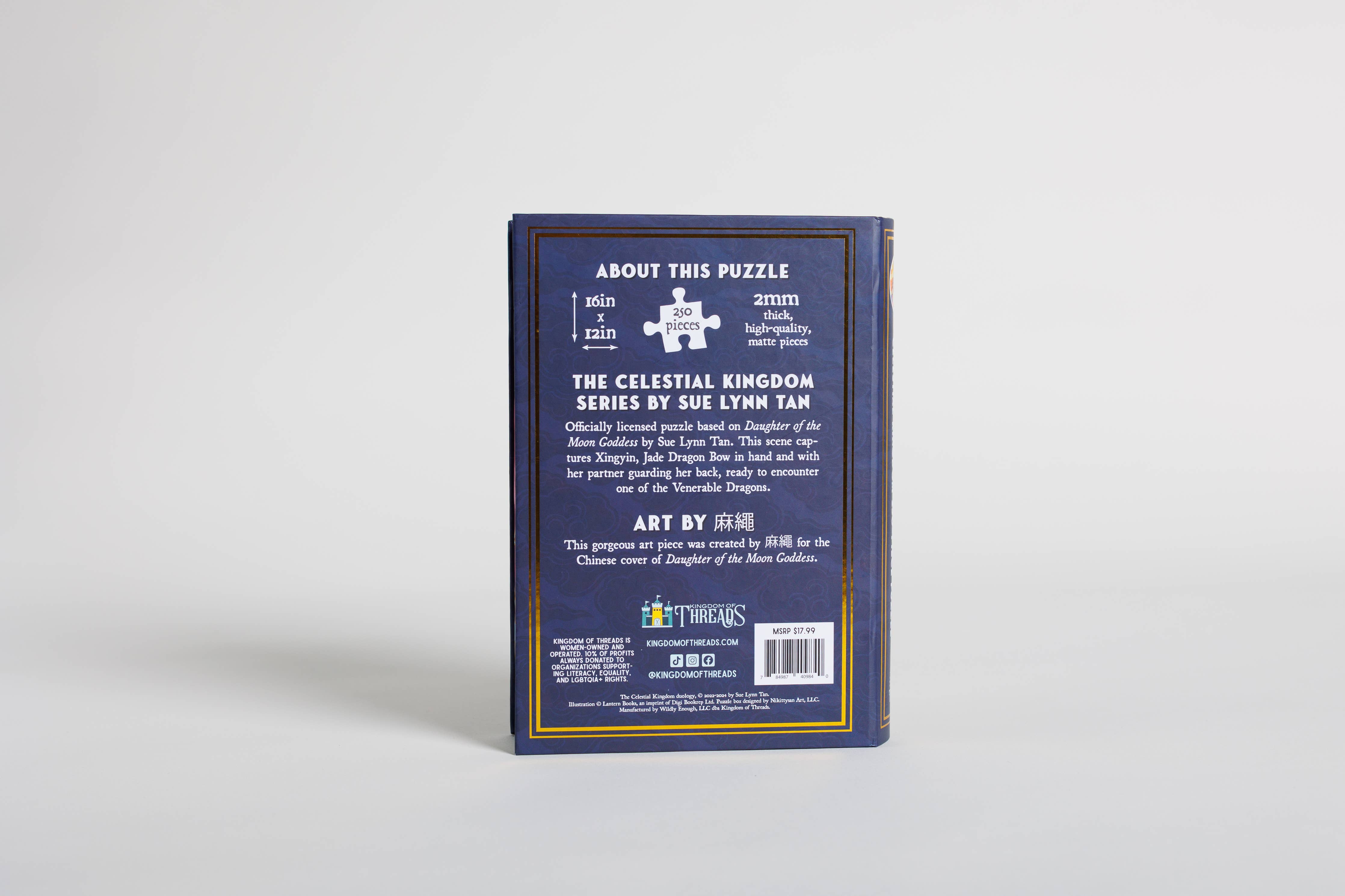 Back of the Daughter of the Moon Goddess Keepsake Puzzle box displaying series information on a dark blue background.