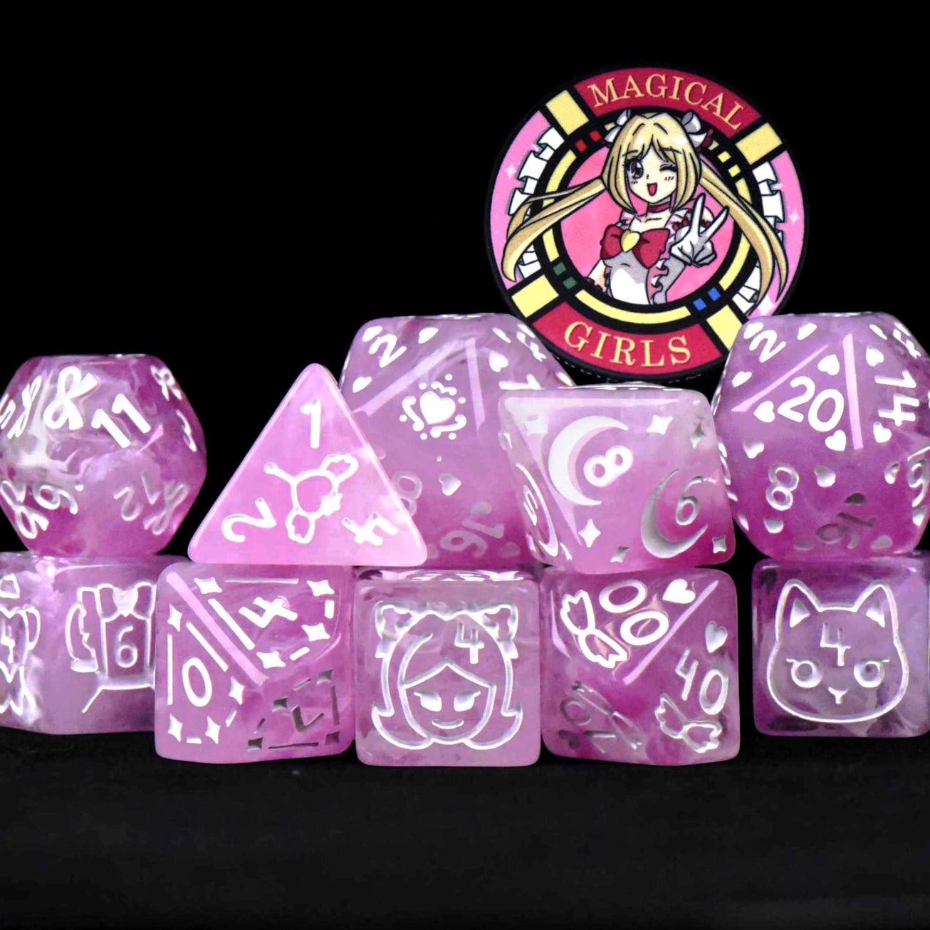 The Magical Girls 11 Dice Set with 11 pink semi-translucent polyhedral dice and an anime-themed badge.
