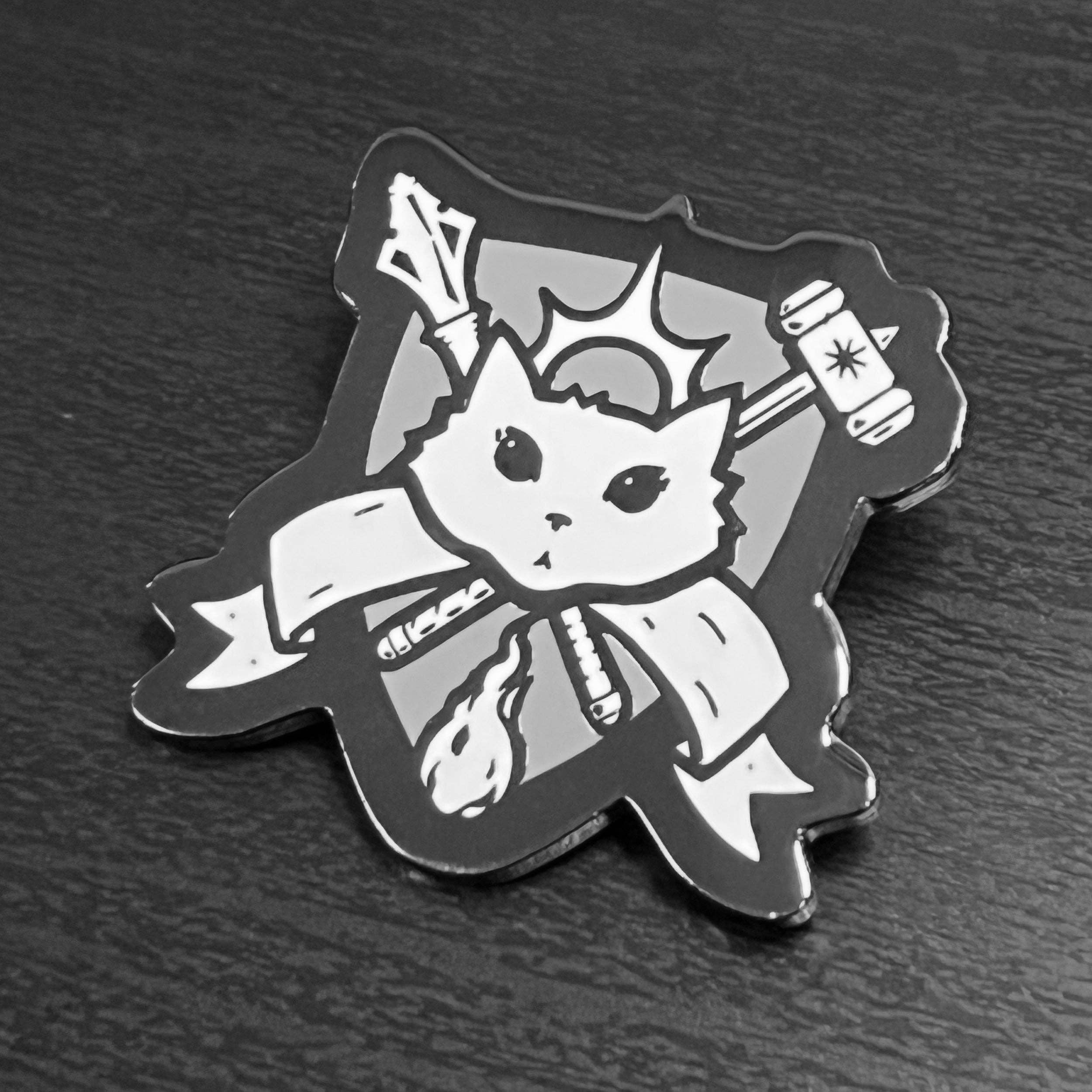 Cleric Enamel Pin featuring a stylized cat with crown, staff, sword, and book; hard enamel with black nickel.