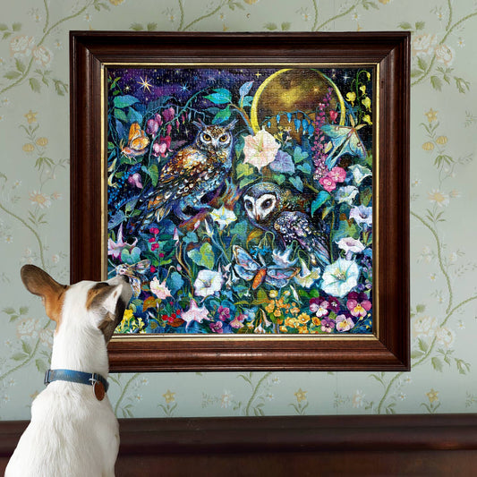 Moon Garden 1000 Piece Puzzle with a dog looking at the box; puzzle image shows two owls in a moonlit floral scene.