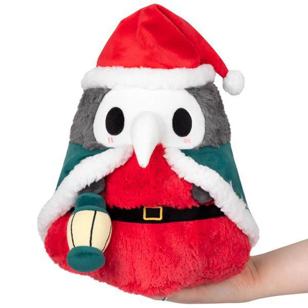 Mini Squishable Festive Plague Doctor plush wearing a Santa hat and cloak.