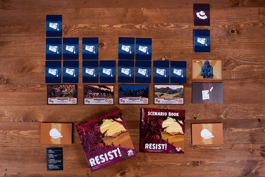 Resist cards arranged in rows with game boxes on a wooden table.