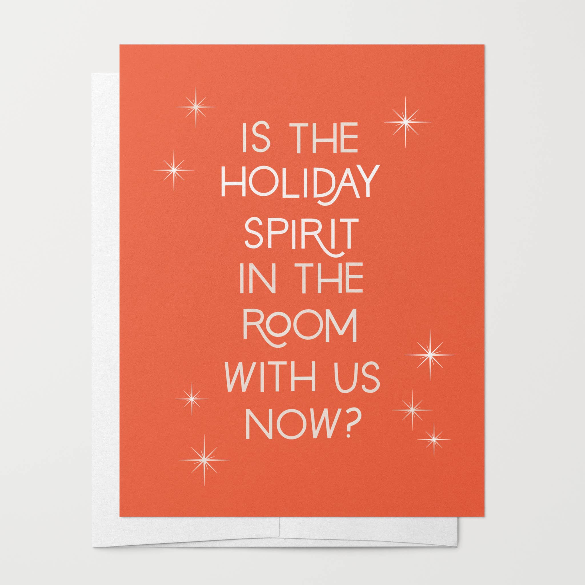 Red greeting card with the text Is The Holiday Spirit In The Room With Us Now? and white starbursts.