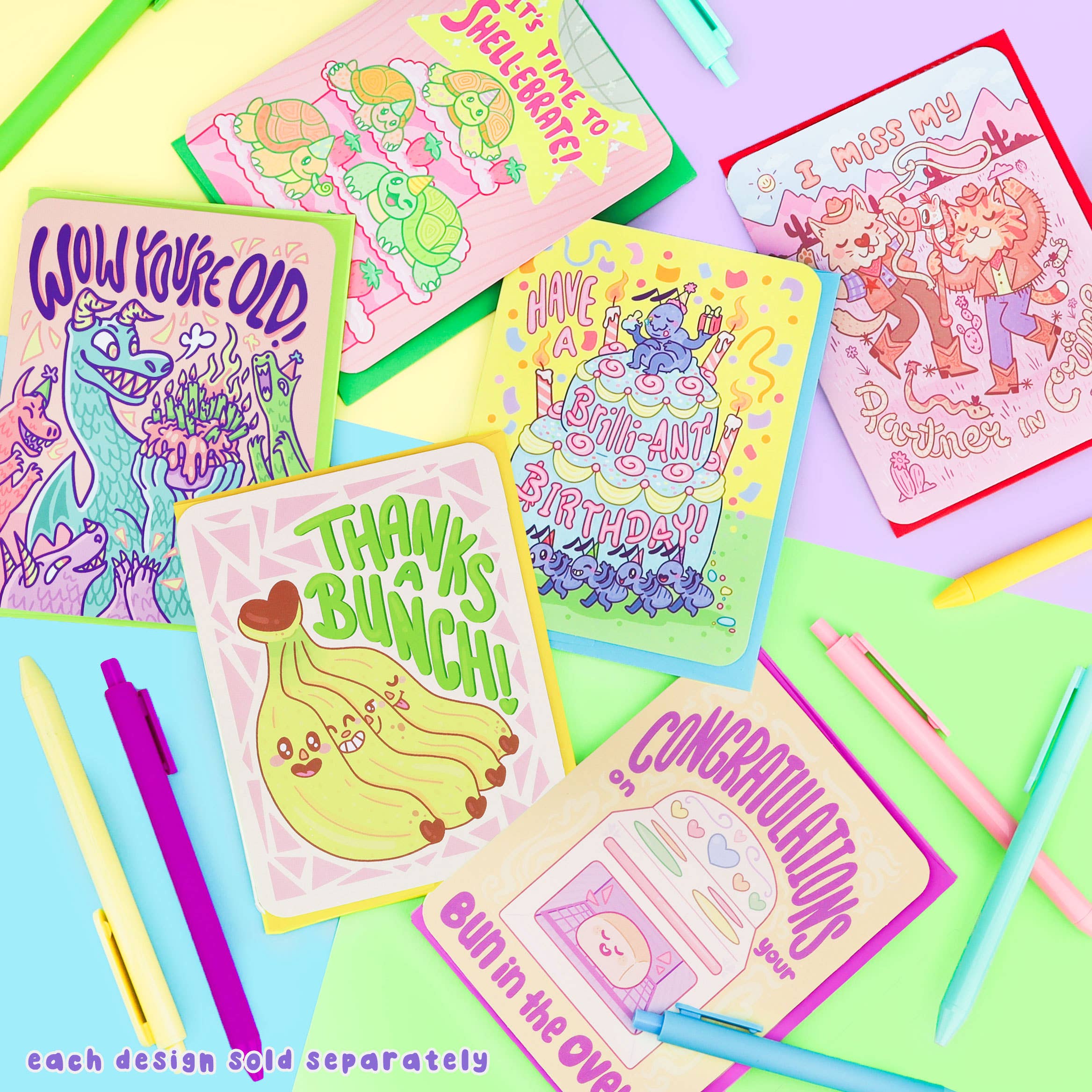 Six Turtles Soup cards, including Wow Youre Old Dragon Birthday Card, with pastel pens and a pencil.