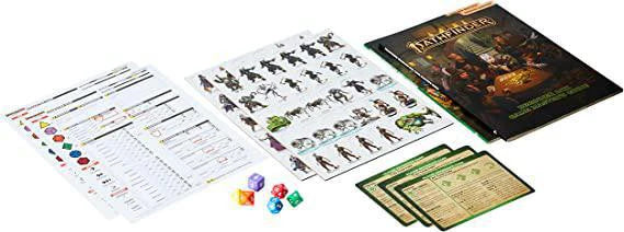 Pathfinder RPG 2e Beginner Box with rulebook, character sheets, tokens, game cards, and colorful dice.