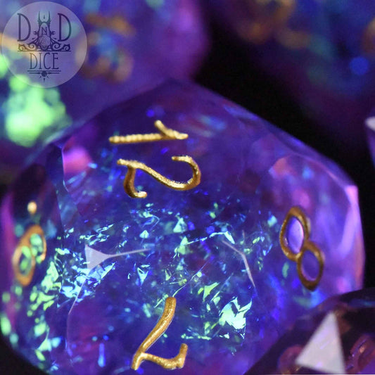 Crown Jewels Imperial dice in purple-blue resin with gold numbers and a crystal-like texture.