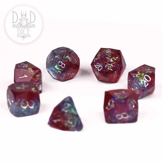 Crown Jewels Bordeaux handmade 7-dice set with red, blue, and glitter accents in white resin.