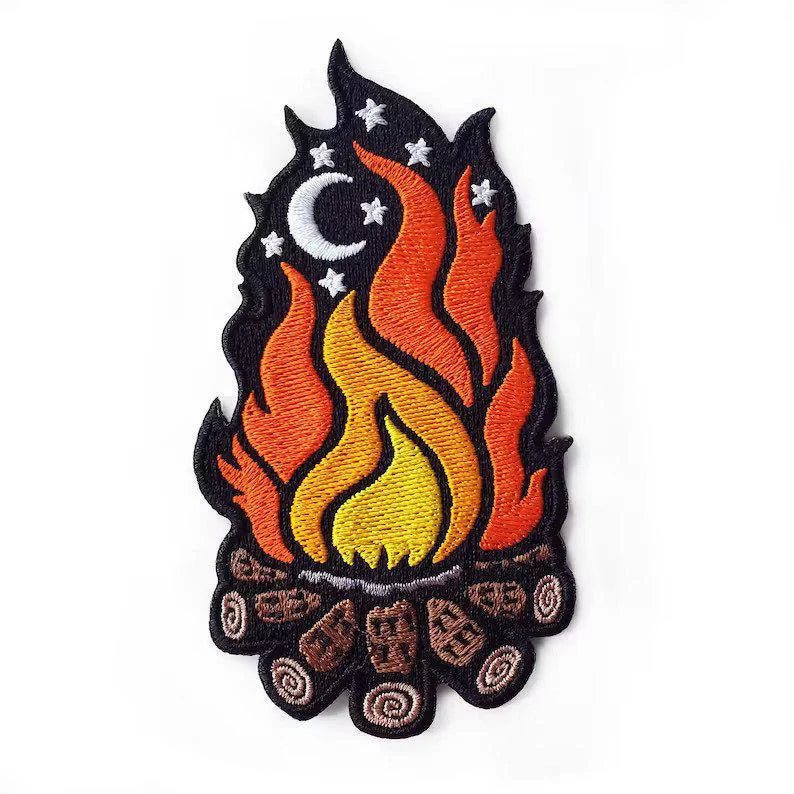 Kolorspun Pins Campfire Patch, embroidered iron-on with logs, orange flames, stars, and a crescent moon.