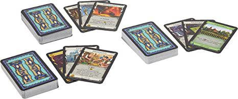 Dominion Alchemy card stacks, some face up showing artwork, others face down with blue patterned backs.