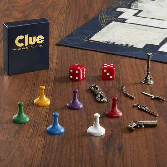 Clue Signature Collection game pieces, weapons, and dice arranged with the game board.