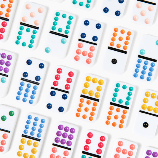 Canvas Classics Mexican Train Dominoes with raised, colorful dots on white tiles.
