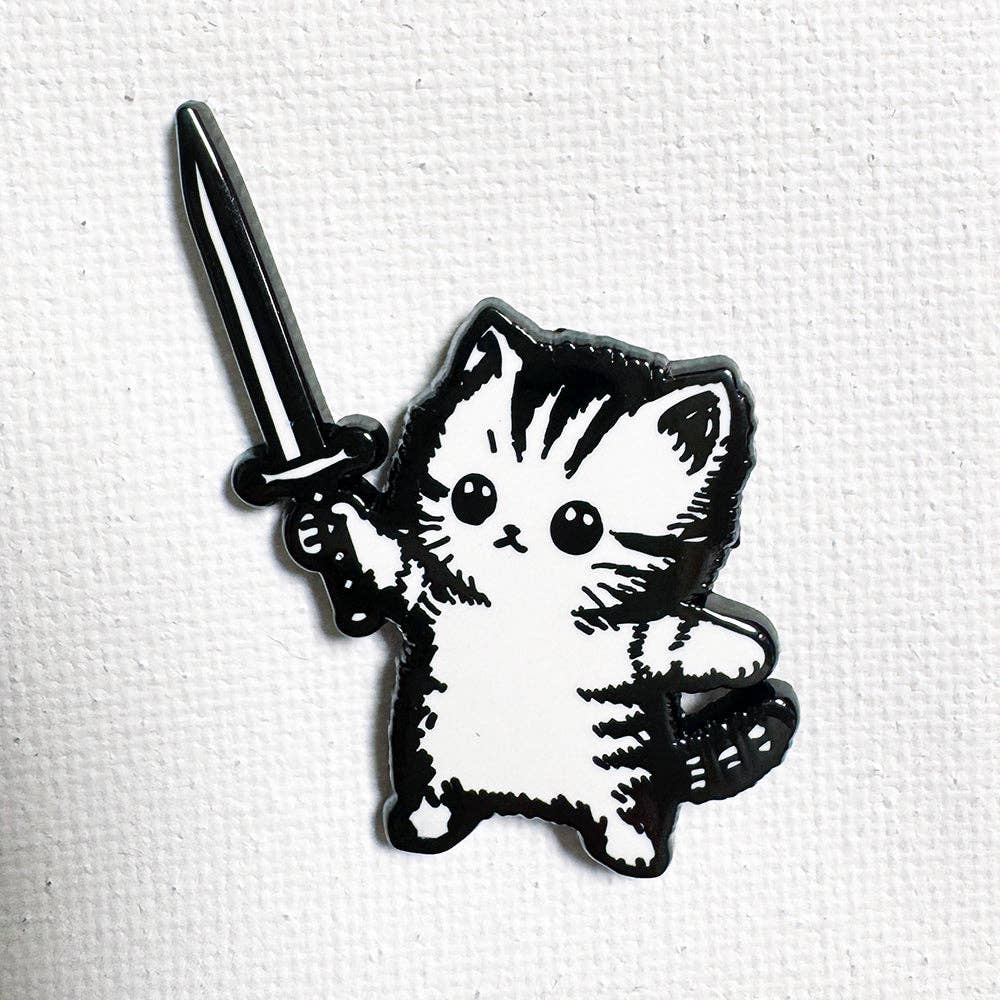 Sword Kitty pin: 1.25-inch black nickel enamel kitten with a sword, rubber clutch backing.