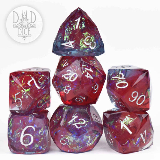 Crown Jewels Bordeaux Handmade 7-dice set, red and blue polyhedral dice with white numbers.