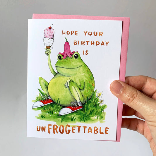 Unfrogettable Frog Birthday Card with a frog wearing red sneakers and a flower hat, holding an ice cream cone.