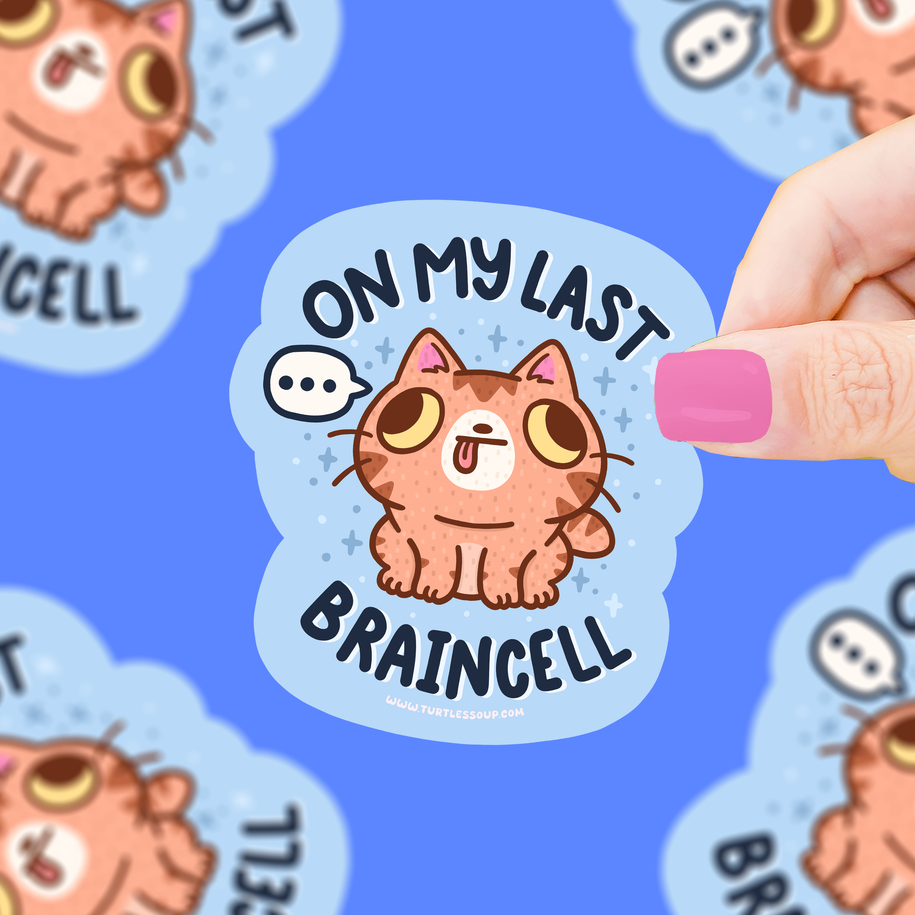 Last Braincell anti-work vinyl sticker with dazed cat and text on blue background held in hand.