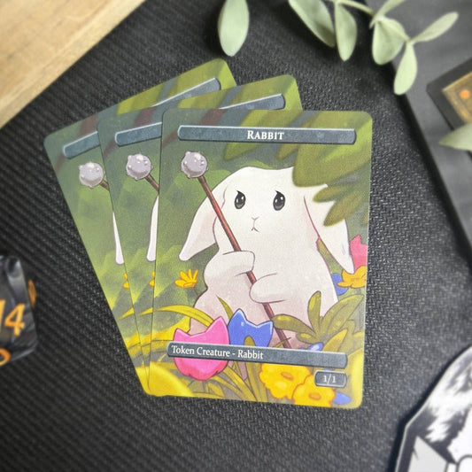 Rabbit & 2/2 Cat Token Set with a white bunny in a meadow, displayed on a dark tabletop.
