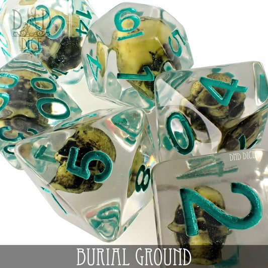 Burial Ground clear resin dice with teal numbers and tiny skulls inside, grouped together.