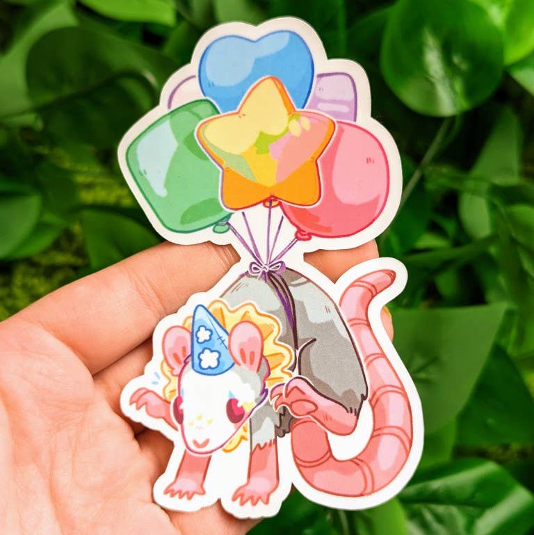 Rat Party Sticker featuring a rat with a balloon and blue hat, held in hand.