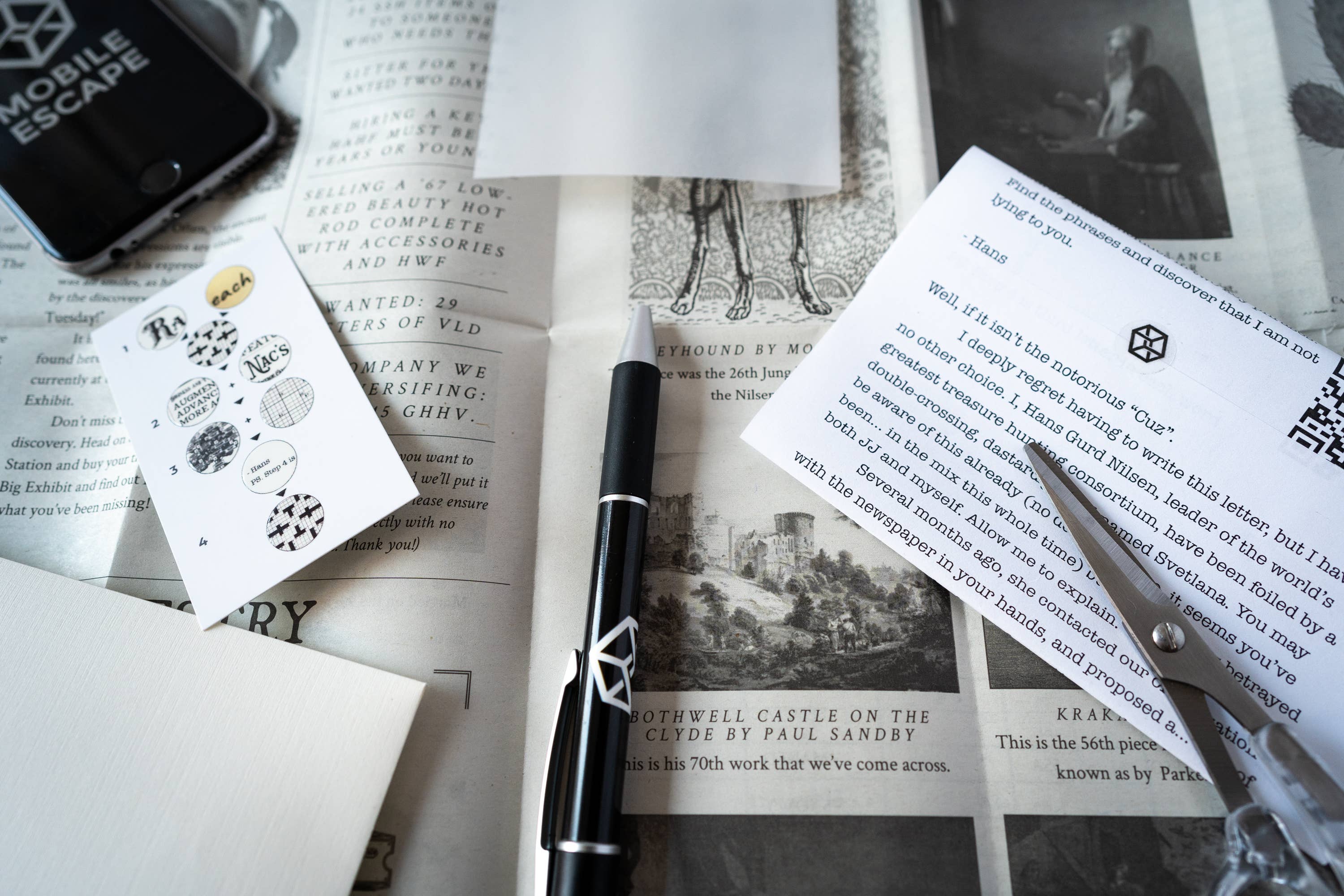 Family Secrets Series: Episode 10 game with game pieces, pen, scissors, and clue cards displayed on a newspaper.