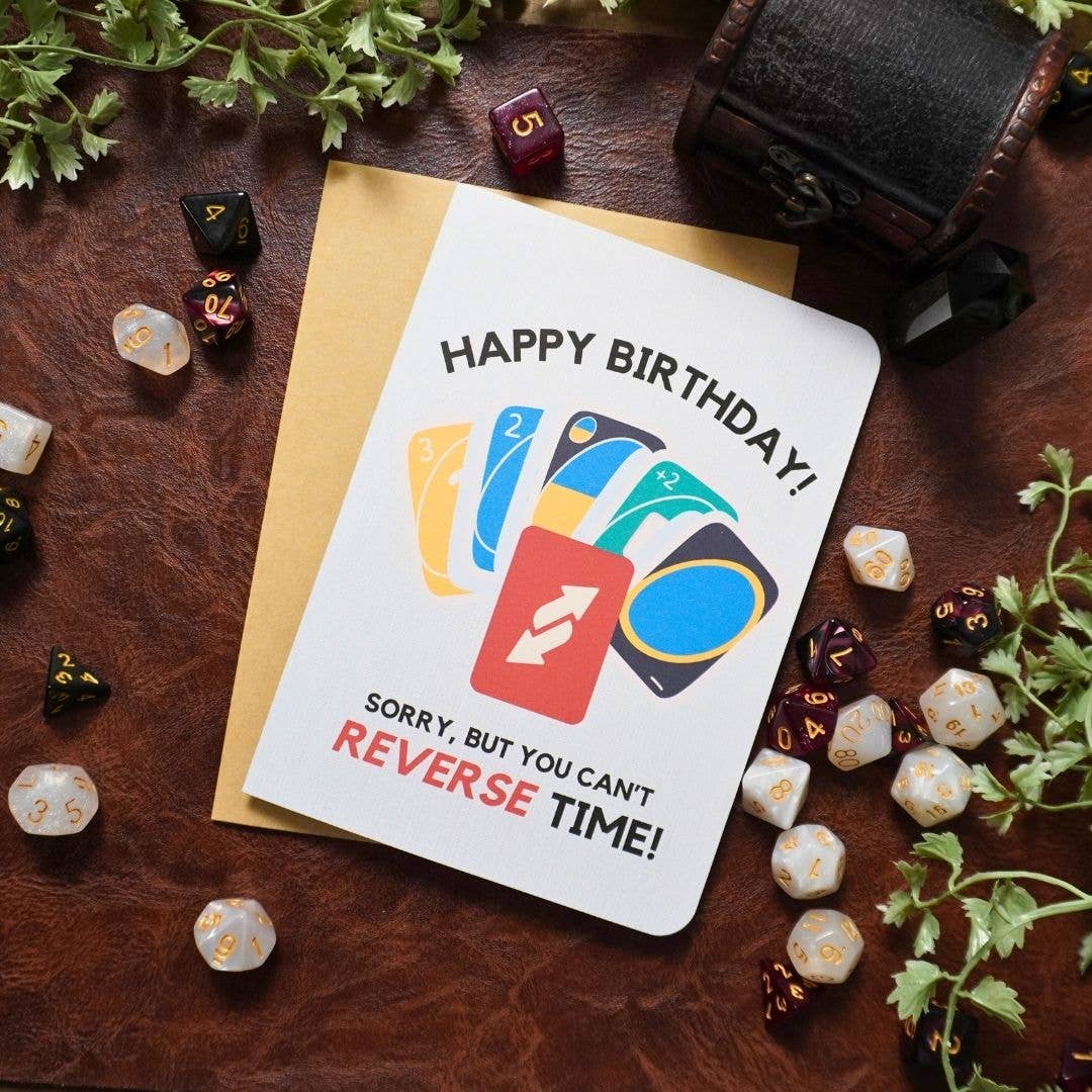 UNO-themed birthday card featuring dice, plants, and Sorry, but you can’t REVERSE TIME text. 5x7 inches.