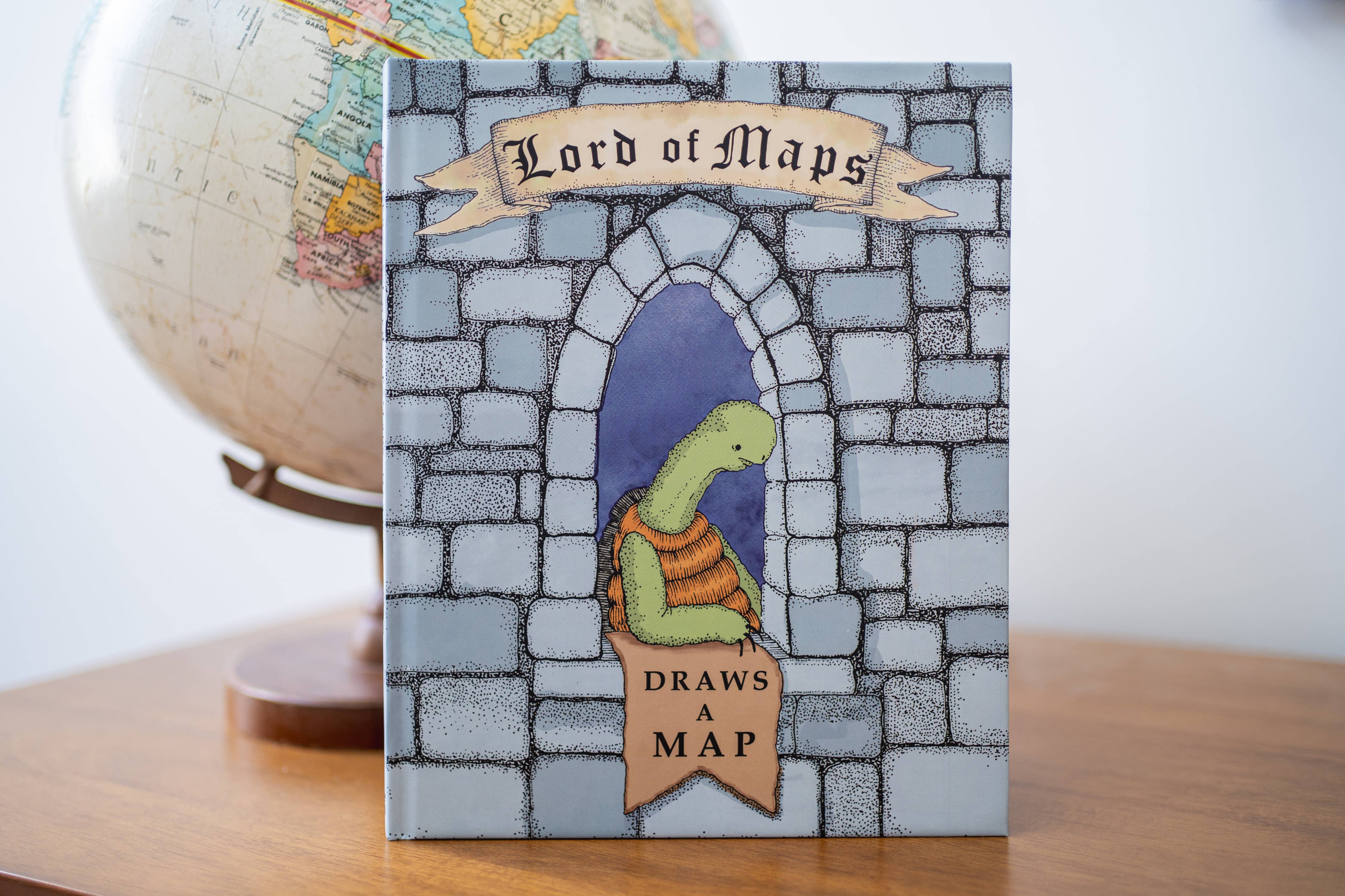 Lord of Maps childrens map drawing book featuring a turtle illustration and a globe on the cover.