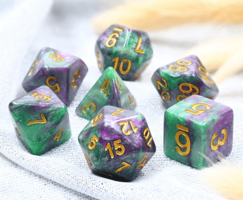 King Cake RPG Dice Set with green and purple polyhedral dice and gold numbers.