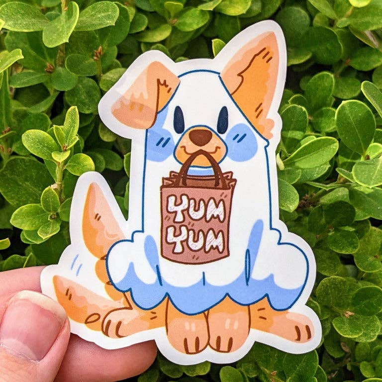 Cartoon dog sticker holding a Yum Yum bag with green leaves from the Halloween Puppies Stickers collection.