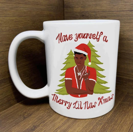 Lil Nas X-mas Mug featuring Lil Nas X in a Santa suit, festive trees, and holiday-themed text.