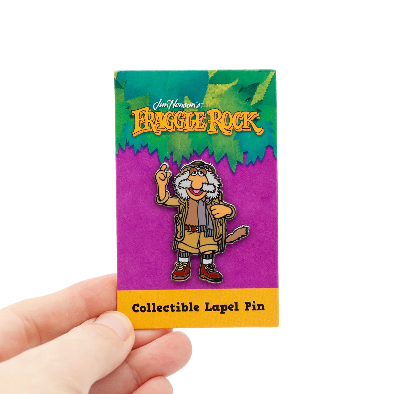 Uncle Traveling Matt Enamel Pin from Fraggle Rock held in a hand.
