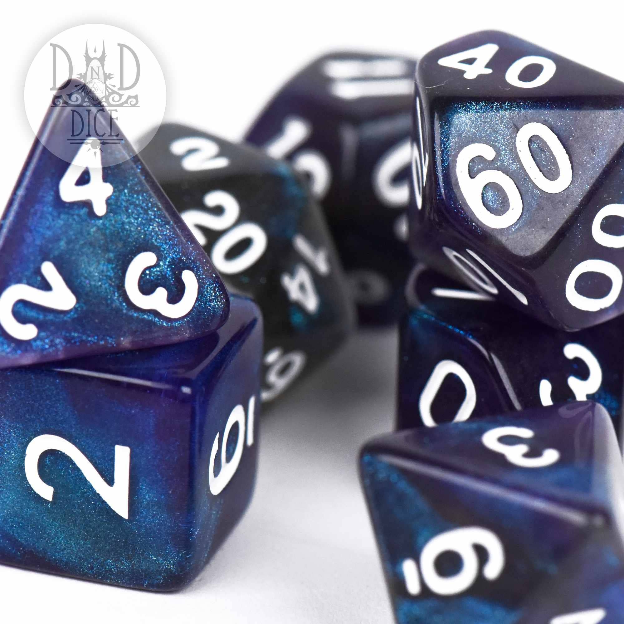 Abyss 7-piece dark blue glittery acrylic DND dice set with white numbers.