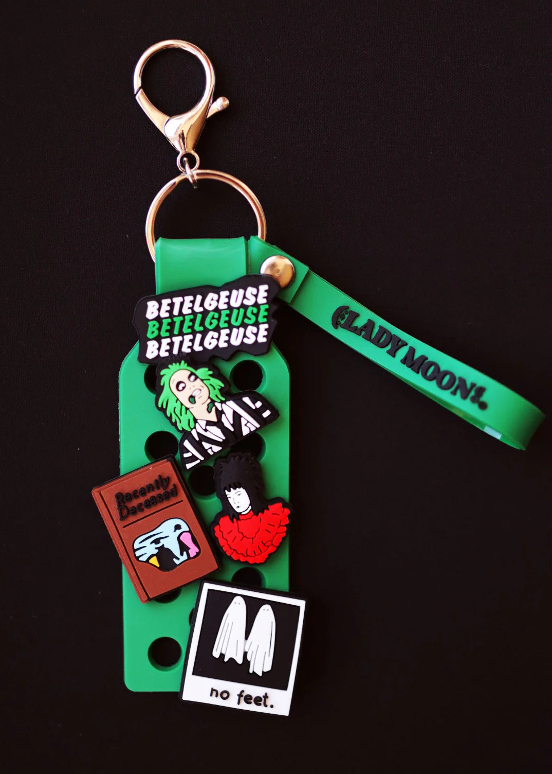Green Lady Moon Shoe Charm Keychain with Beetlejuice-themed charms, faces, a book, and a ghost graphic.