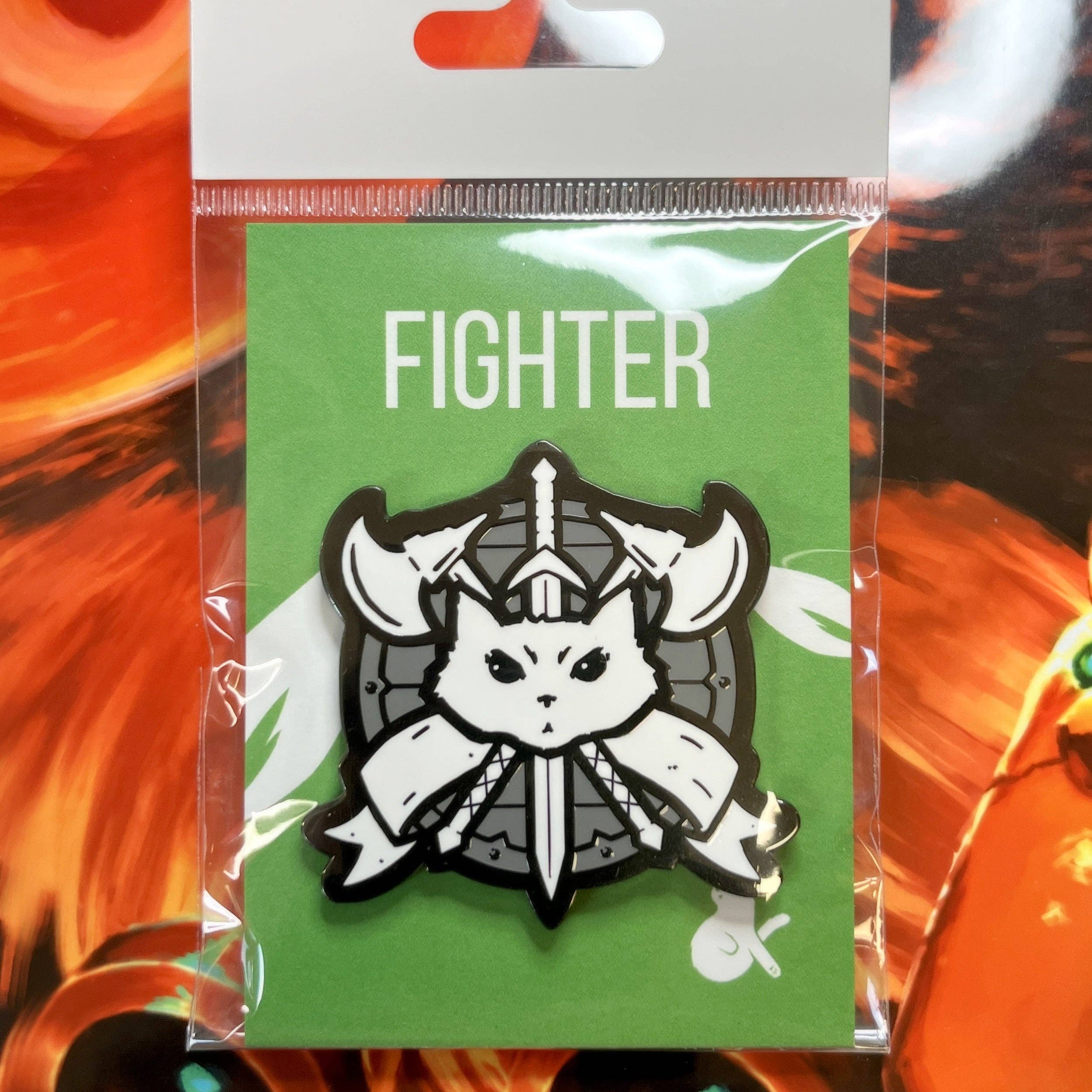 Fighter Enamel Pin with cat face, axes, and sword in black nickel and fiery colors.