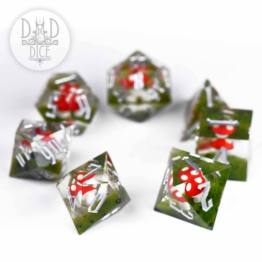 Turf and Toadstools (Handmade) set: 7 green resin dice with red and white mushrooms and silver numbers.