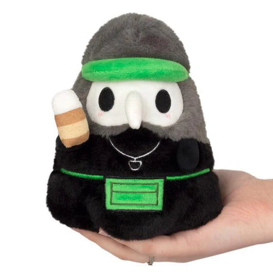 Squishable Alter Ego Plague Doctor Barista plush with white beak mask and green accents.