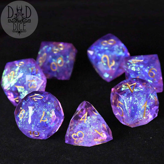 Crown Jewels Imperial 7-piece dice set, purple-blue glitter resin with gold numbers.
