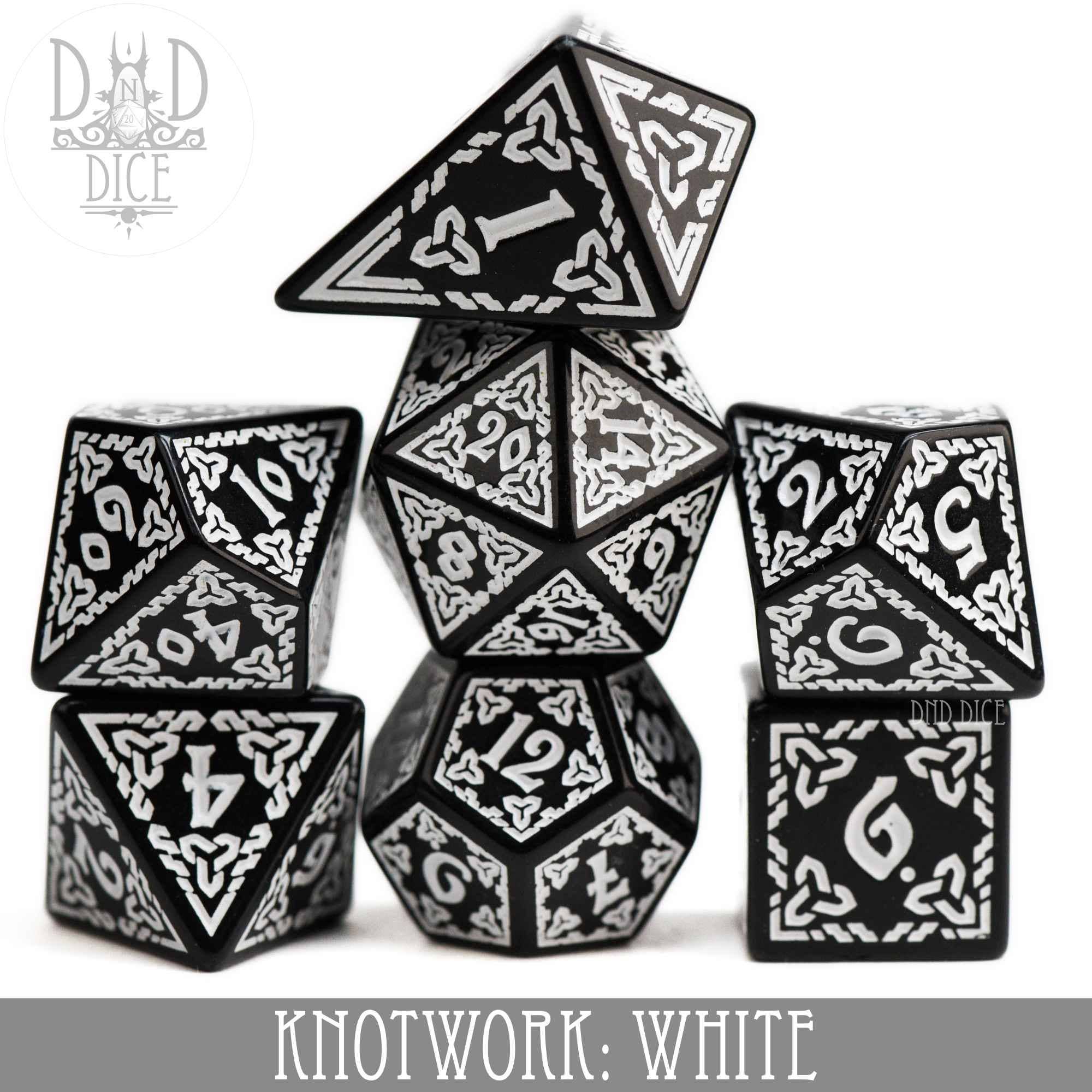 Knotwork: White 7-piece black acrylic dice set with white knotwork designs and a teardrop-shaped D4.