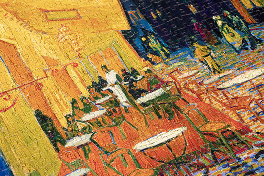 1000-piece puzzle featuring Vincent van Goghs Cafe Terrace café night scene.