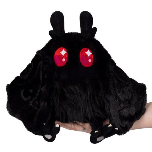 Mini Squishable Baby Mothman plush toy with red eyes and wings, inspired by West Virginia folklore.