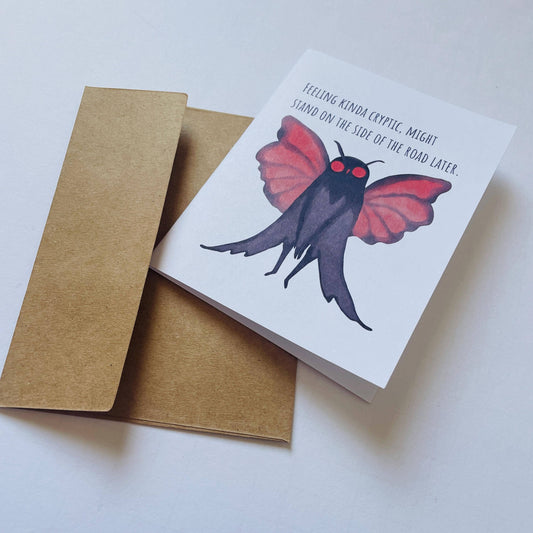 The Mothman Cryptic Humor Card For Any Occasion features a red-eyed moth and the phrase Feeling kinda cryptic.