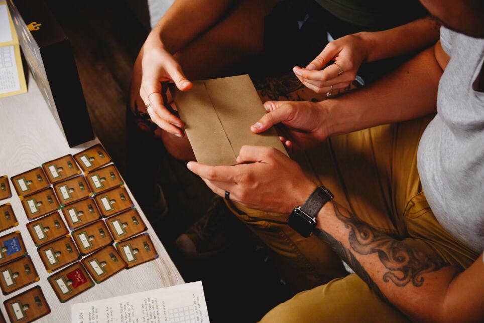 Madame Medoras House of Curiosities Escape-Room Board Game with two people playing.