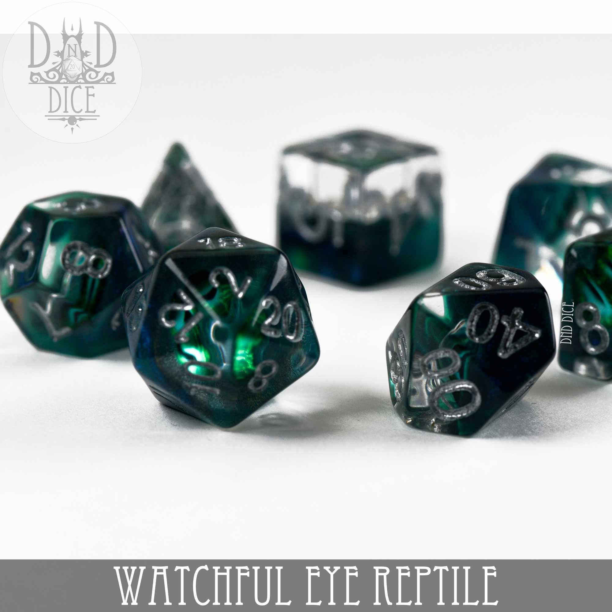 The Watchful Eye Reptile green and silver resin 7-dice set for tabletop gaming.