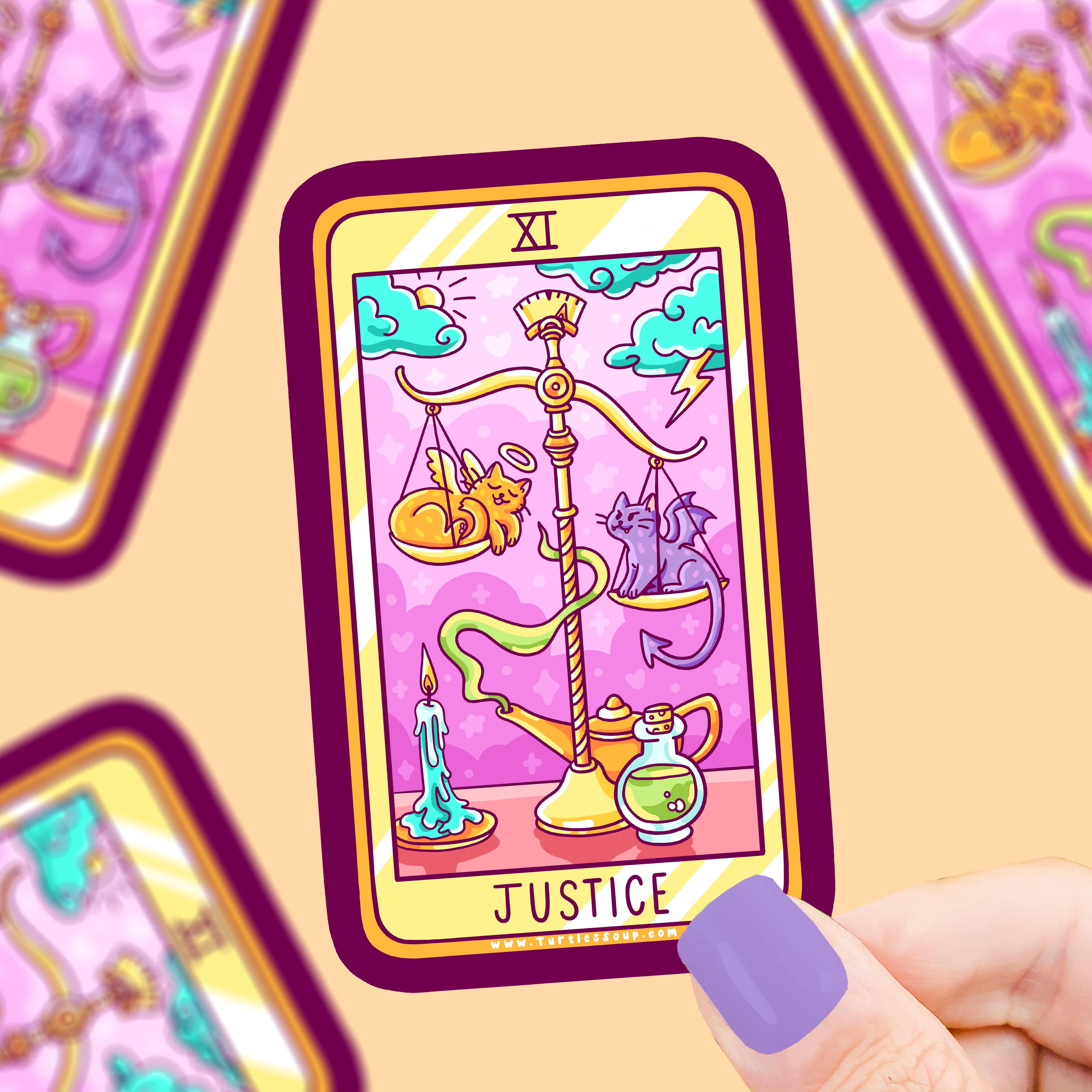 Justice Cat Major Arcana Tarot Card Vinyl Sticker with scales and cats, held by a hand with purple nails.