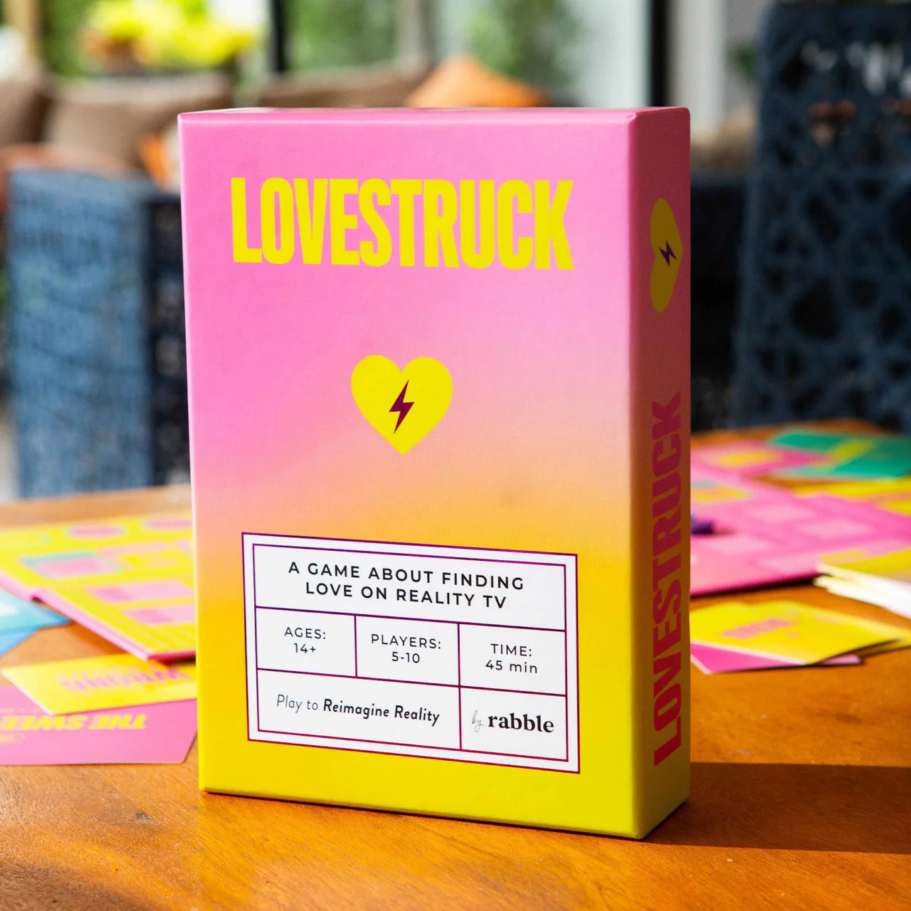Lovestruck board game box with game cards displayed behind it.