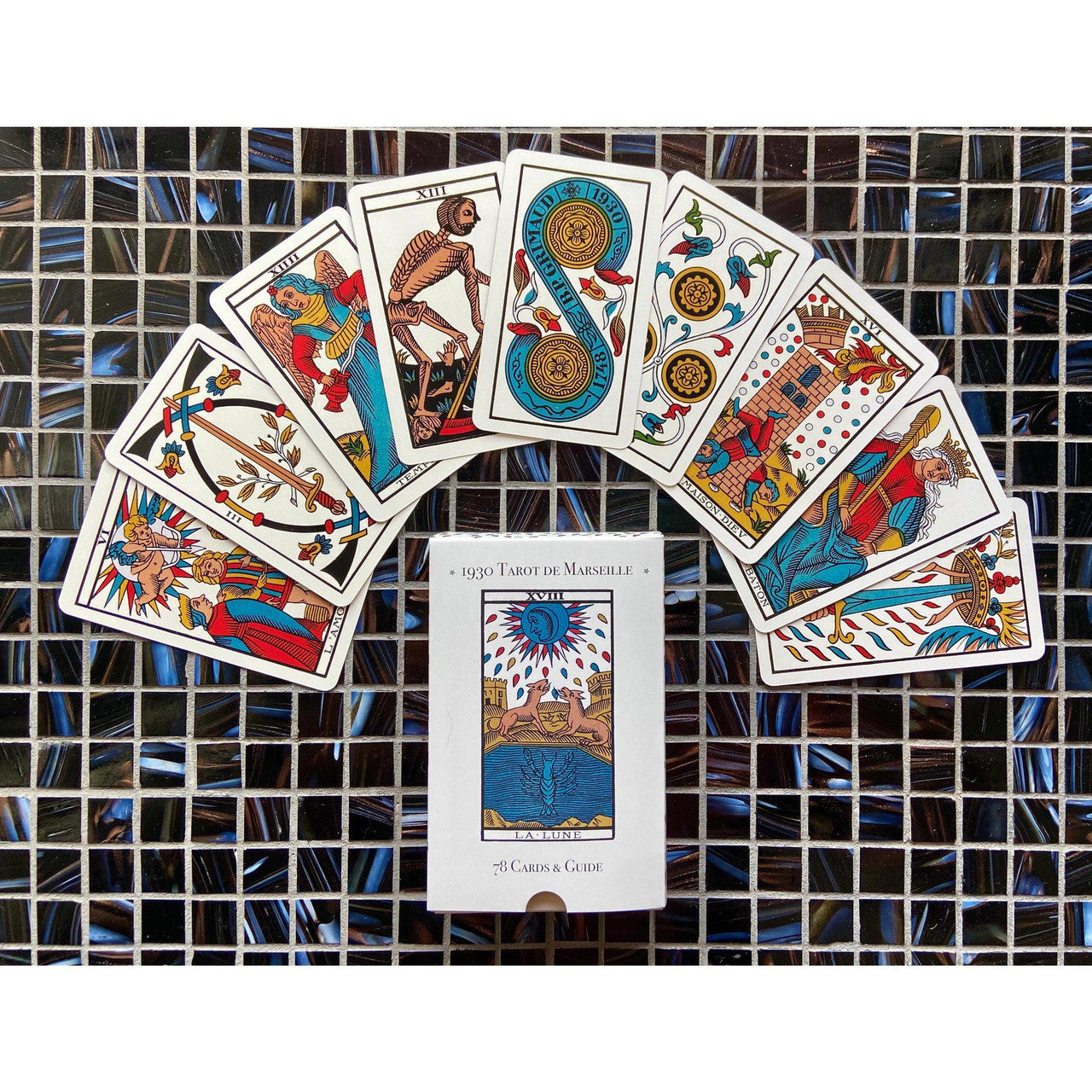 1930 Tarot de Marseille & Guide |1930 box with eight Tarot cards fanned above it.