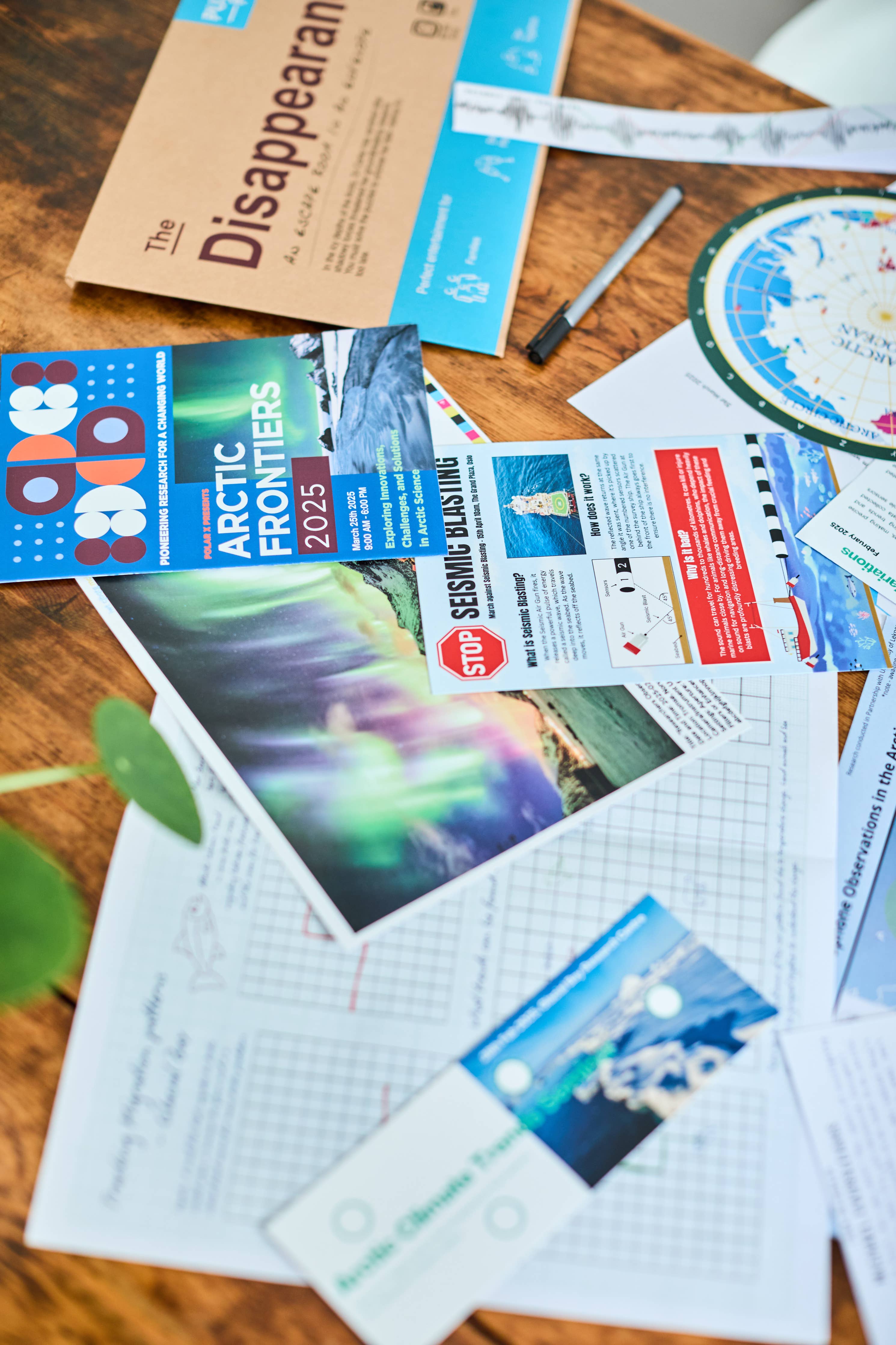 Escape Room in An Envelope: The Disappearance game materials spread out on a wooden table.