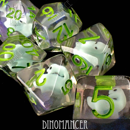 Dinomancer resin dice set, transparent with green numbers and white dinosaur figures inside.