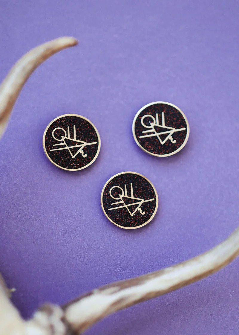 The Cult Symbol Yellowjackets Pin with black and white abstract design.