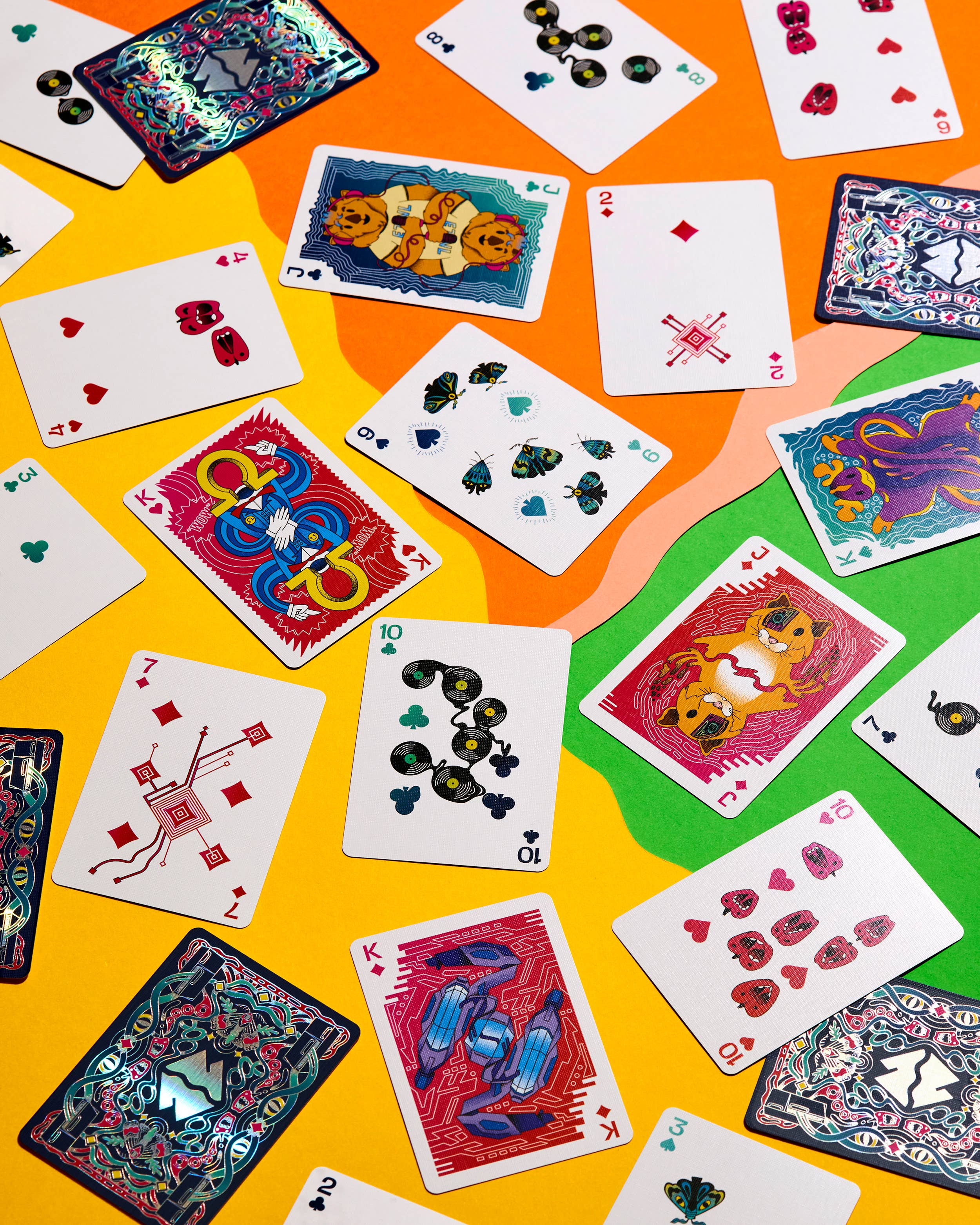 Meow Wolf playing cards with colorful surrealist illustrations.