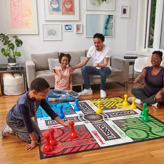 SORRY Giant Edition game with large pieces being played by four people in a living room.