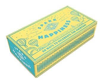 Spark Happiness box, yellow and blue, with 50 prompts. Hot air balloon artwork on packaging.